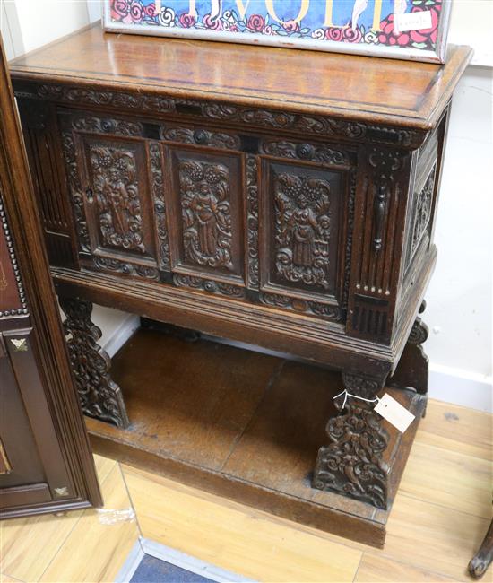 A 17th century style carved oak panelled cupboard W.72cm